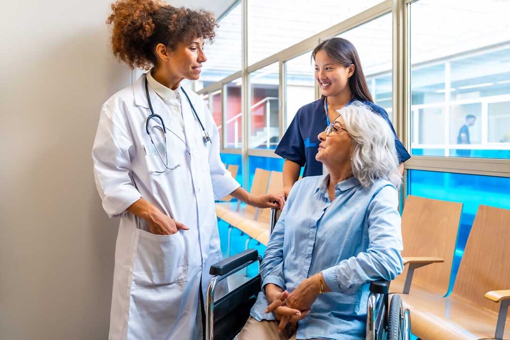 Older adult and family member reviewing a daily care checklist at a kitchen table.